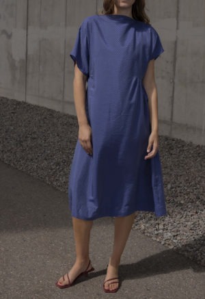 woman in blue boatneck midi length dress