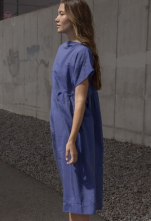 woman in blue boatneck midi length dress