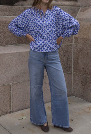 woman in dark blue floral button-up and jeans