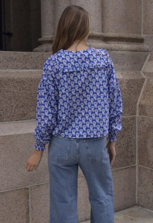 woman in dark blue floral button-up and jeans