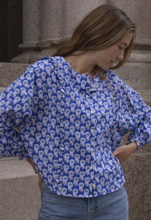 woman in dark blue floral button-up and jeans