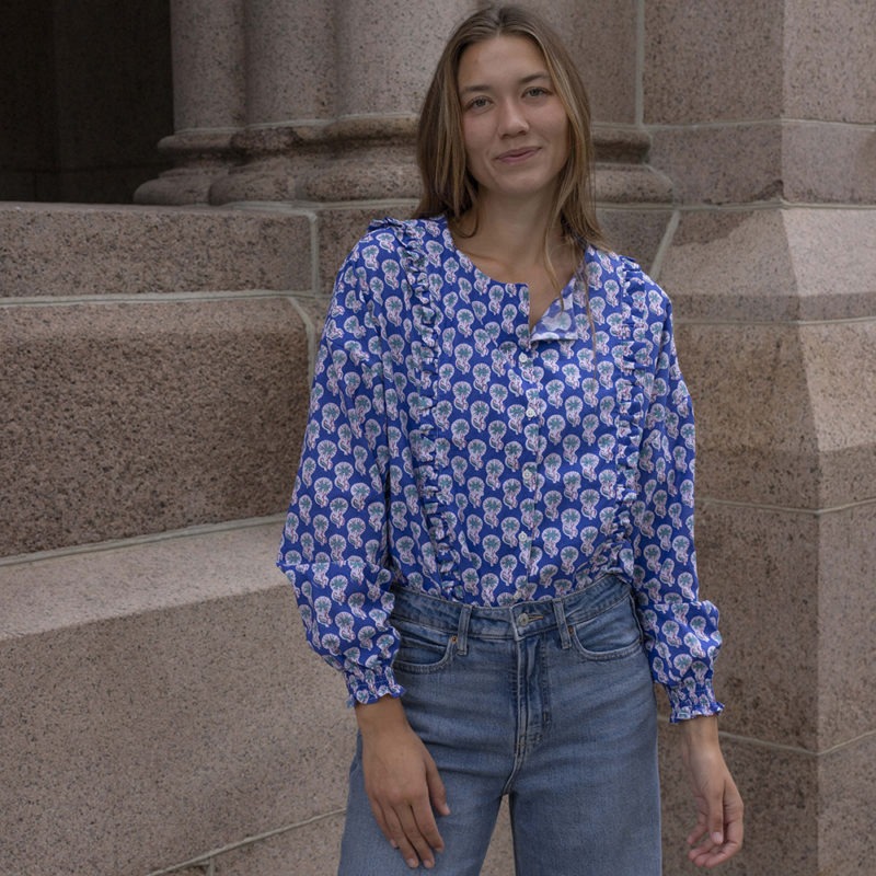 woman in dark blue floral button-up and jeans