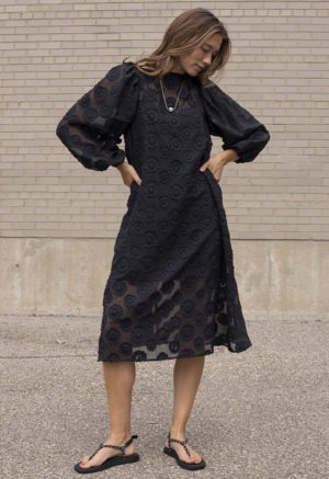 woman in black sheer floral dress