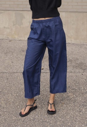 woman in dark navy pant and black sweater