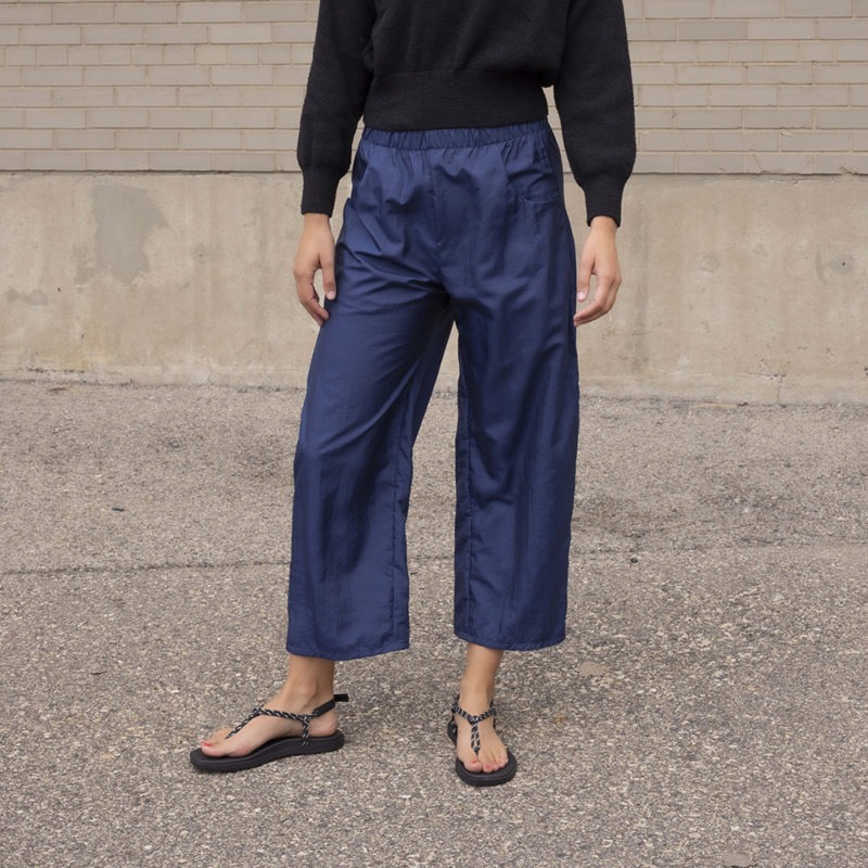 woman in dark navy pant and black sweater