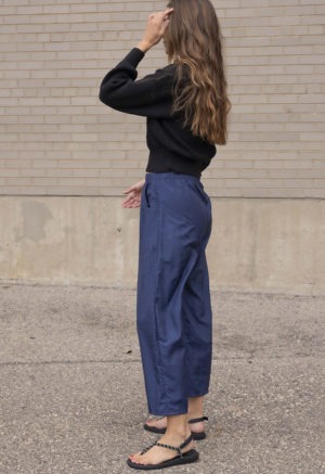woman in dark navy pant and black sweater