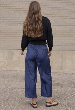 woman in dark navy pant and black sweater