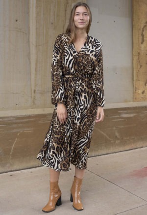 woman in cheetah print v-neck long sleeve midi dress