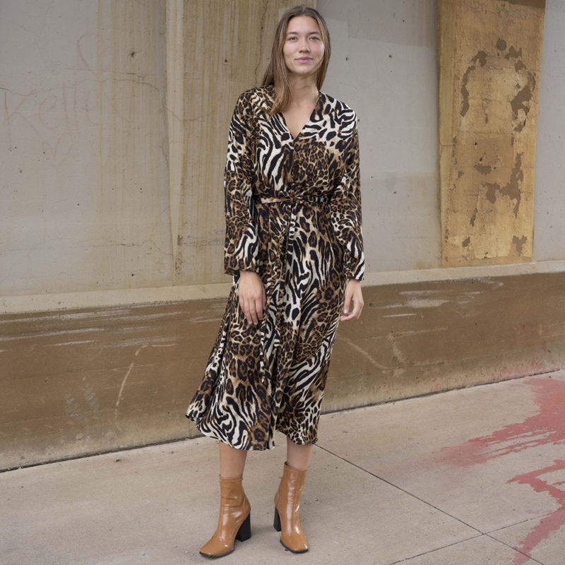 woman in cheetah print v-neck long sleeve midi dress