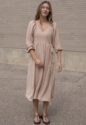 woman in blush wrap dress