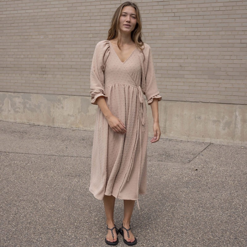 woman in blush wrap dress