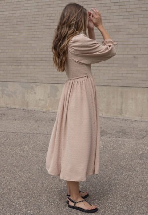 woman in blush wrap dress