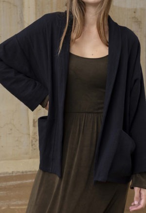 woman in dark brown midi length dress and black oversized jacket