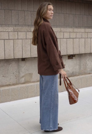 woman in brown oversized short jacket and jeans