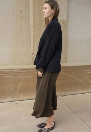 woman in dark brown midi length dress and black oversized jacket