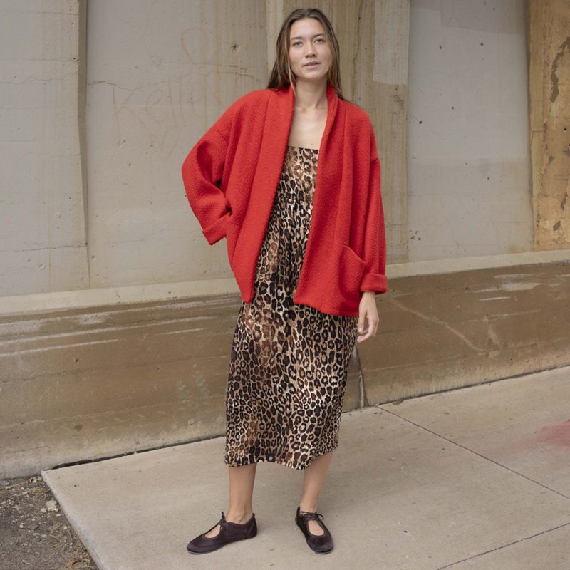 woman in red jacket, leopard print dress