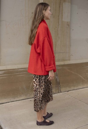 woman in red jacket, leopard print dress