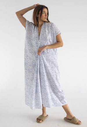 woman in midi length white cotton kaftan