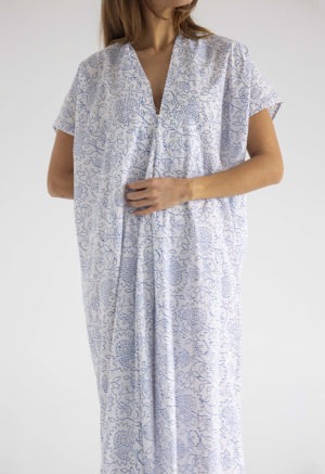 woman in midi length white cotton kaftan