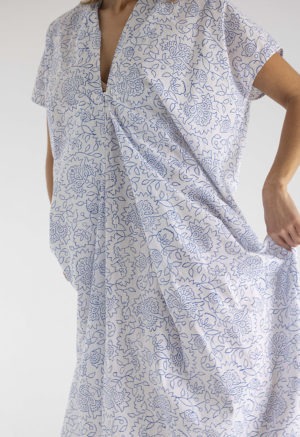 woman in midi length white cotton kaftan