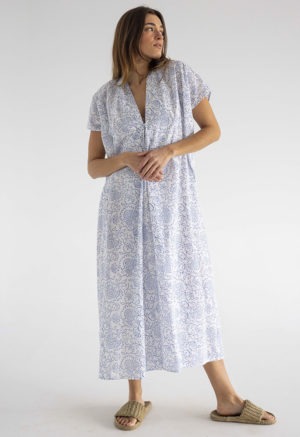 woman in midi length white cotton kaftan