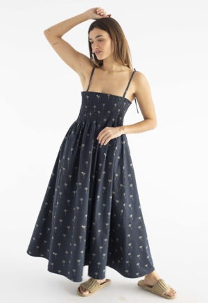 women in black spaghetti strap sundress with palm tree print