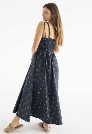 women in black spaghetti strap sundress with palm tree print