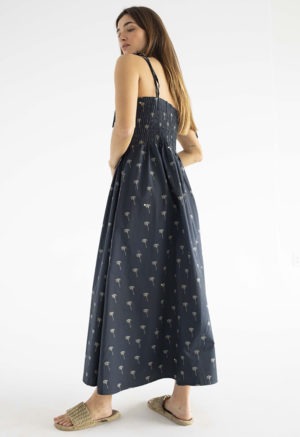 women in black spaghetti strap sundress with palm tree print