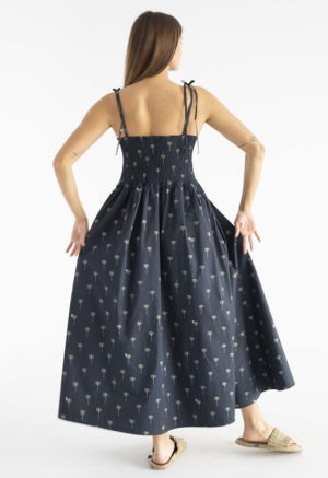 women in black spaghetti strap sundress with palm tree print