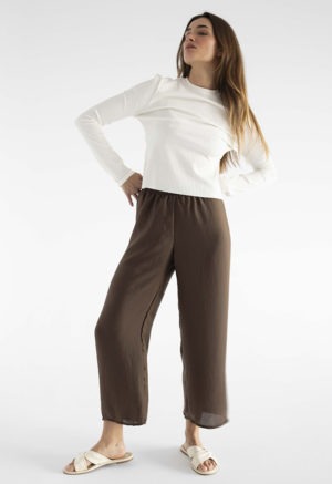 woman in brown wide-leg pants and white rib long sleeve top