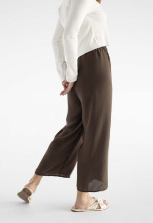 woman in brown wide-leg pants and white rib long sleeve top