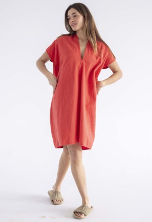 woman in bright poppy red v-neck, knee length dress