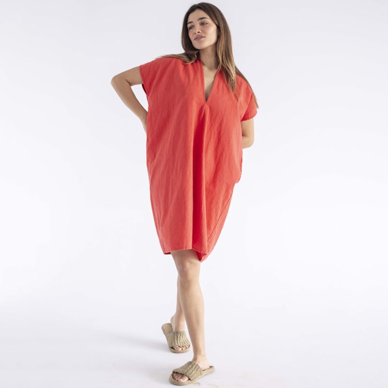 woman in bright poppy red v-neck, knee length dress