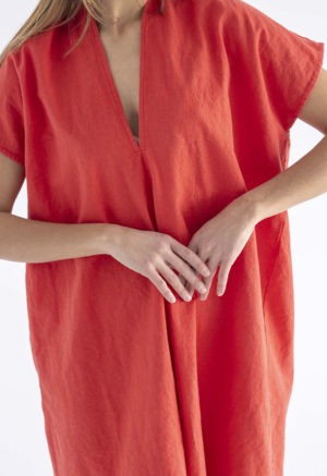 woman in bright poppy red v-neck, knee length dress