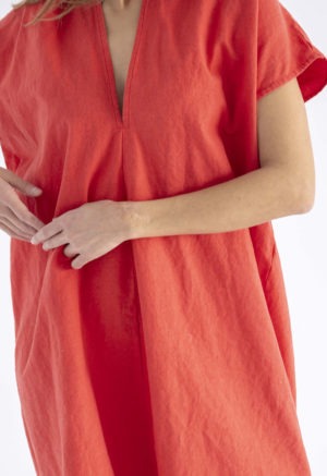 woman in bright poppy red v-neck, knee length dress