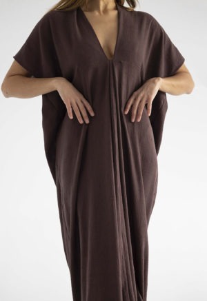 woman in dark brown kaftan with pleat in the front v-neck