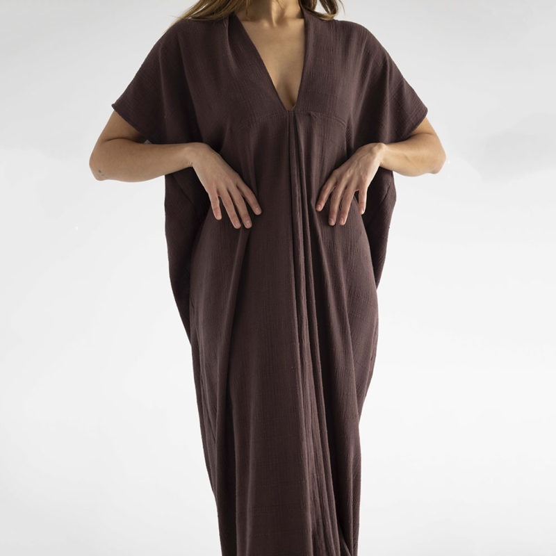 woman in dark brown kaftan with pleat in the front v-neck