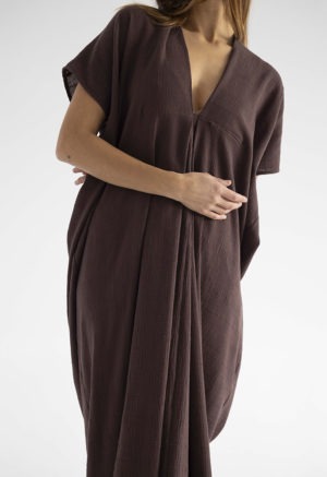 woman in dark brown kaftan with pleat in the front v-neck