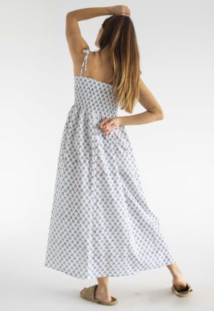 women in white and teal floral sundress