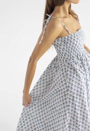 women in white and teal floral sundress