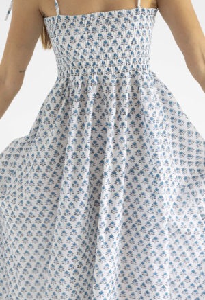 women in white and teal floral sundress