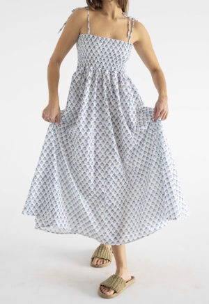 women in white and teal floral sundress