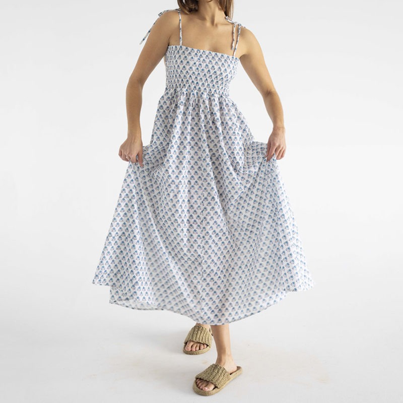 women in white and teal floral sundress