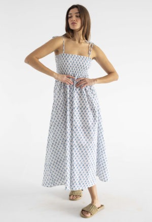 women in white and teal floral sundress