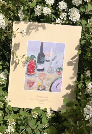 book sitting in bushes of white flowers