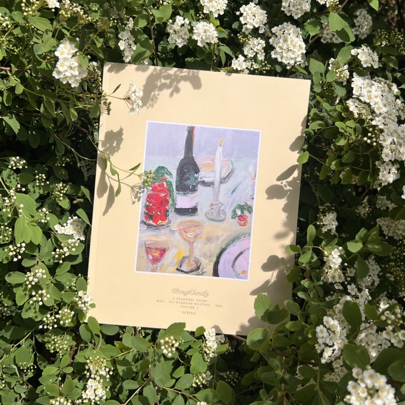 book sitting in bushes of white flowers