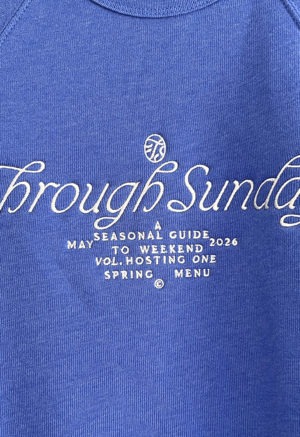 blue sweatshirt with white embroidered writing at chest