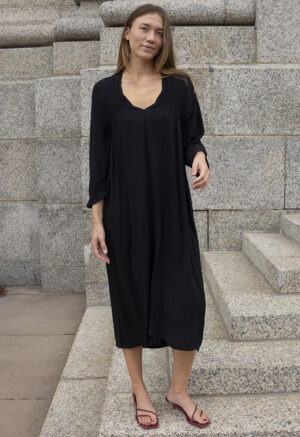 woman in black v-neck dress