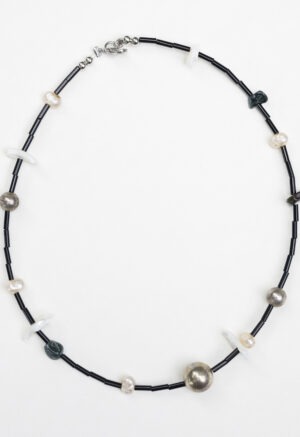 black necklace on white backdrop
