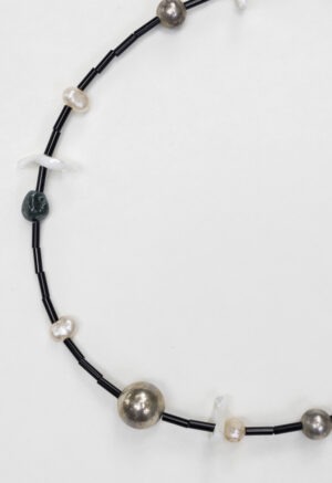black necklace on white backdrop